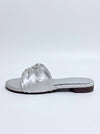 A single metallic silver flat slide sandal with ruched straps and a jeweled embellishment on the toe strap, shown from a side profile against a light gray background.