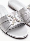 Silver satin slide sandals with a rhinestone-embellished X-shaped embellishment on the strap, shown on a clean white background.
