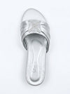 A single metallic silver slide sandal with a wide strap featuring a rhinestone-embellished bow, shown from a top-down view on a white background.